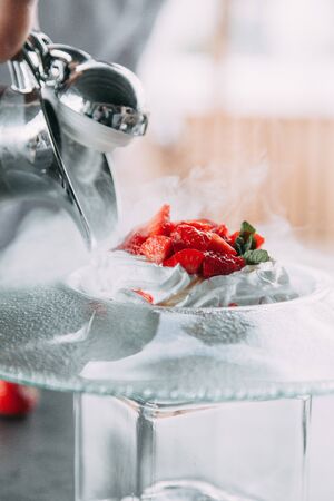the preparation of the dessert Pavlova with strawberries and in the supply of liquid nitrogenの写真素材