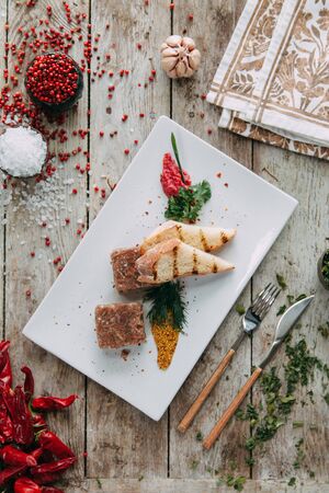 aspic with horseradish and bread slices on wooden backgroundの写真素材