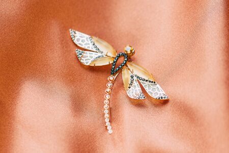 handmade jewelry made of gold with precious stones on an abstract backgroundの写真素材