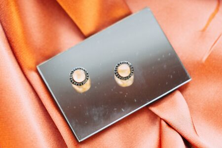 handmade jewelry made of gold with precious stones on an abstract backgroundの写真素材