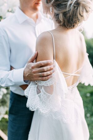  Beautiful couple at sunset in the Park. Wedding ceremony with arch in the forest.の写真素材