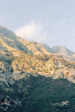 The coast of Positano, Amalfi in Italy. Panorama of the evening city and the streets with shops and cafes. Houses by the sea and the beach. Ancient architecture and temples. View from a postcard on topの写真素材