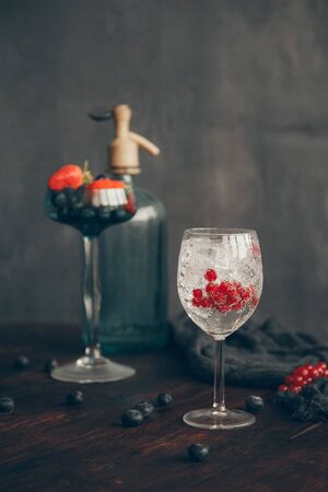 Cocktail with berries blueberries, strawberries and ice on a dark backgroundの写真素材