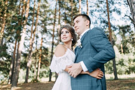 Stylish European wedding at sunset. Happy couple in the forest in nature.の写真素材