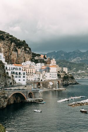 The Amalfi coast and the mountain slopes with plantations of lemons. Panoramic view of the city and nature of Italy. Evening landscapes and winding roads. Sky over the sea and rocks.の写真素材