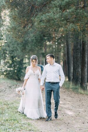 Stylish European wedding at sunset. Happy couple in the forest in nature.の写真素材