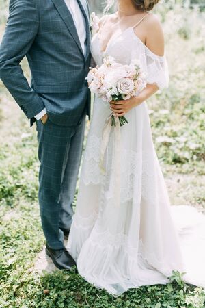 Modern ceremony in European style. Beautiful wedding couple in atmospheric forest with rocks. 