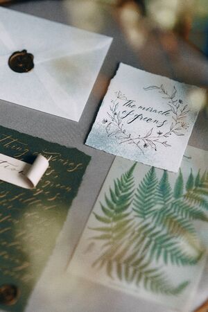 Wedding printing on a chair with fresh spring flowers, invitations and cards in the composition of...