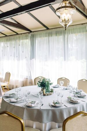 Decor wedding table in the cafe. Floristry and glass glasses at the wedding.の写真素材