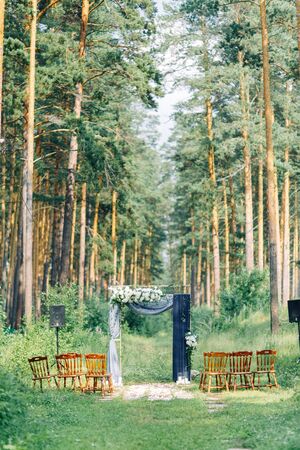 Wedding arch decor with flowers. Bride's bouquet with shoes in the hotel.の写真素材