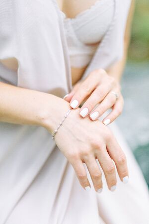 Boudoir photo shoot of the bride in the woods with a bouquet. Flying dress and beautiful girl in the Park.の写真素材