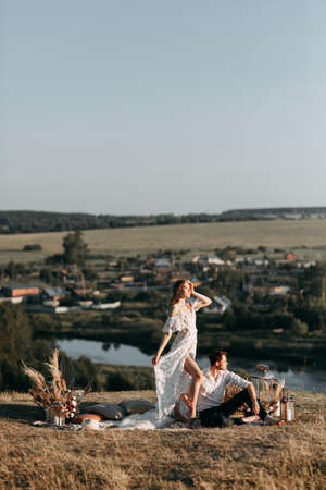 Beautiful wedding couple in nature in boho style. Wedding in the European style of fineart at sunset.の写真素材
