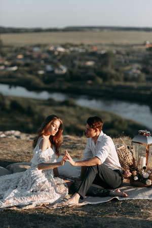 Beautiful wedding couple in nature in boho style. Wedding in the European style of fineart at sunset.の写真素材