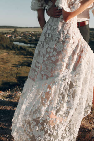 Beautiful wedding couple in nature in boho style. Wedding in the European style of fineart at sunset.の写真素材