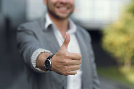 The mans hand shows the class, and points with his finger. The businessman clicks the button with...