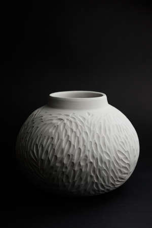 Ceramic clay vase on a bright colored background. Set of textured cups close-up.