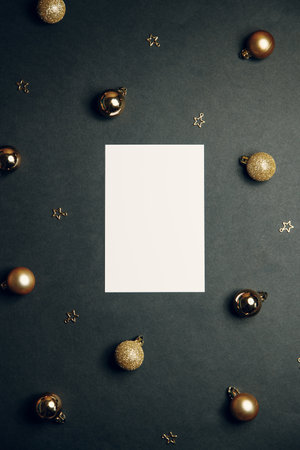 Greeting card frame, with an empty space in the center. Christmas background with fir branches and pine cones on flatley wood background and top view.の写真素材