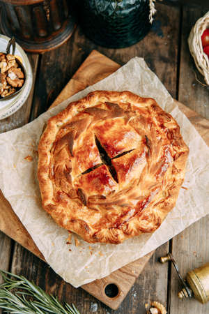 Strawberry and rhubarb pie with cut piece on a marble background.の写真素材