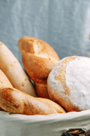 Bread basket close-up. Bread assortment of French baguette and rye bread.
