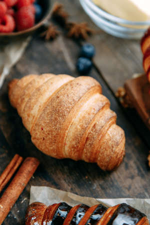 Breakfast with croissants and milk close-up. Freshly baked croissants on a wooden table.