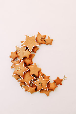 scattered cookies in the shape of a moon on a white background. Christmas ginger cookies in the shape of stars.の写真素材