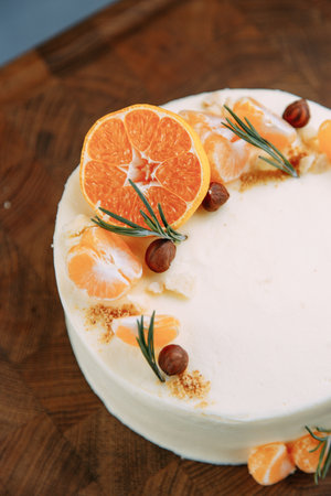 Sweet cake with fresh berries on a wooden background. Cake with delicate cream and fruit close-up.の写真素材