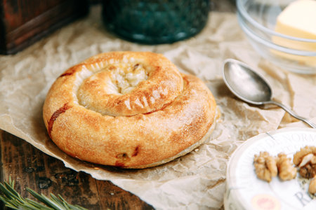 Swirling round pie close-up. Traditional Moldovan and Romanian cake in the shape of a snail.の写真素材
