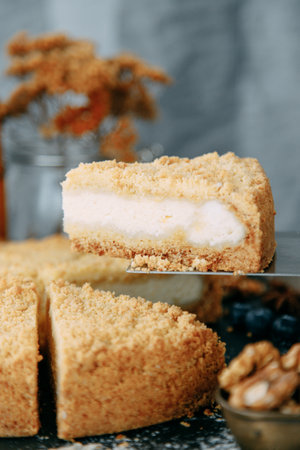 Sweet dessert with cream on the table. Sour cream cake cut in close-up.の写真素材