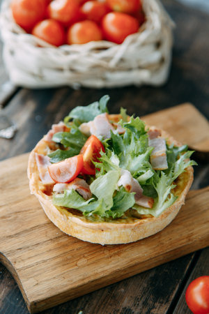 Tartlet made of yeast-free dough close-up. Hot appetizer with mushrooms, chicken and herbs.の写真素材