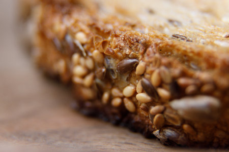 The texture of the bread with blurred background. Close-up on traditional bread with cereals and...