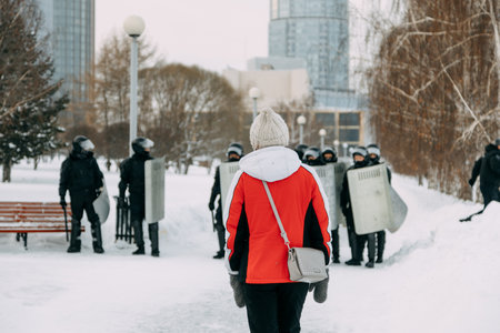 Yekaterinburg, Russia - january 23, 2021: A protest rally in Moscow on January 23 in support of Navalny. A man on the background of riot police close-up.のeditorial素材