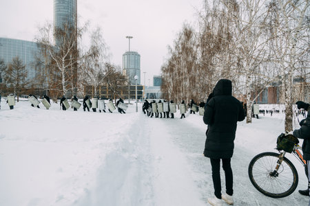 Yekaterinburg, Russia - January 23, 2021: Riot police stand in a chain against the citizens. Police cordon in the park of Yekaterinburg in winter.のeditorial素材