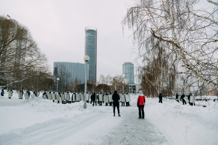 Yekaterinburg, Russia - January 23, 2021: Riot police stand in a chain against the citizens. Police cordon in the park of Yekaterinburg in winter.のeditorial素材