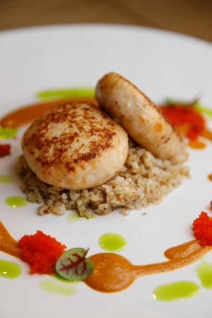 Restaurant serving dishes, close-up. Cutlets with buckwheat and mushrooms, and sauce around.
