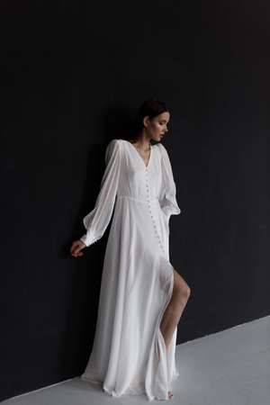 Fine art in a photo on a black background. Stylish bride in a Russian wedding in the European style in the studio.の写真素材