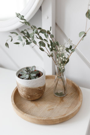 Dry flower decoration in a vase, natural light. Dried flowers on a white table, decor in the interior.の写真素材