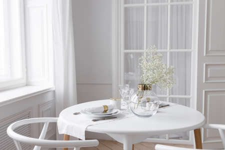 Set wooden table in a bright interior, photo studio. White loft interior in a Scandinavian style...
