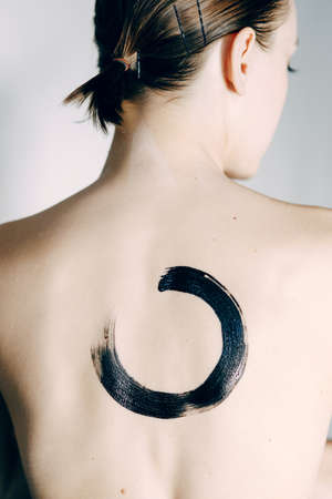 A beautiful girl poses in the studio, in the style of fine art. Fashion art photo of a young sensual...