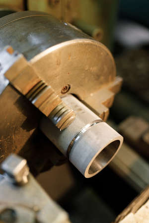 A lathe with a blank in the spindle. Old equipment at the factory from the mid-20th century.
