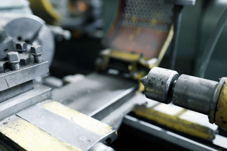 Old locksmith lathe, components and tools. Lathe close-up, metal with a blurred background.