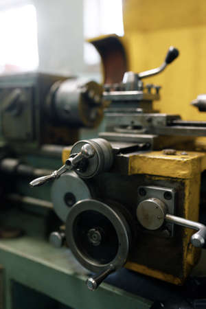 Old locksmith lathe, components and tools. Lathe close-up, metal with a blurred background.
