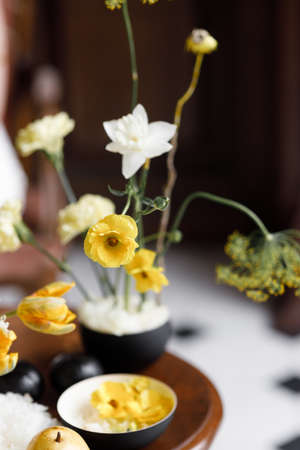 Wedding decor in trendy shades, composition on the table with printing. A delicate composition with yellow flowers and fruits, with wedding invitations.の写真素材
