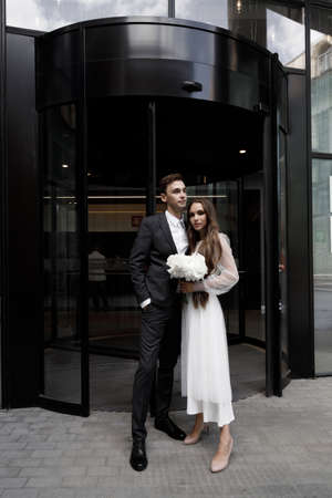 Newlyweds with a dark hotel, a wedding photo shoot. Stylish wedding, shooting with flashes.の写真素材