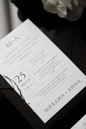 A set of dark wedding printing on a wooden background. Wedding invitation, trendy black background with flower petals.の写真素材