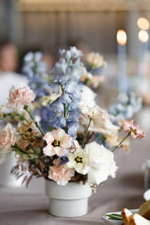 Wedding decor on the table decoration. A bouquet of white flowers, a composition with candles.の写真素材