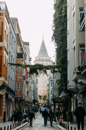 ISTANBUL, TURKEY - NOVEMBER 14: An ancient Turkish famous landmark in the Beyoglu area, European side. Galata Kulesi Tower and a street in the old city. Architecture of the former Constantinople.のeditorial素材