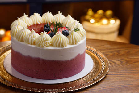 Chocolate cake with whipped cream and fresh berries. Close-up with blurred background.の写真素材