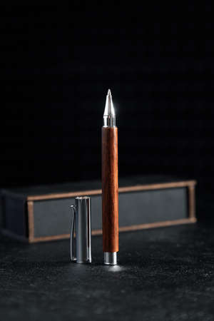 luxury gift pen. A set of expensive military pens in wooden boxes, compositions on a dark background with attributes.の写真素材