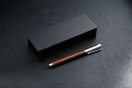 luxury gift pen. A set of expensive military pens in wooden boxes, compositions on a dark background with attributes.の写真素材