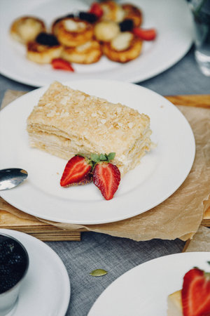 French breakfast with blueberries and strawberries. Pancakes with honey and berries for breakfast.の写真素材